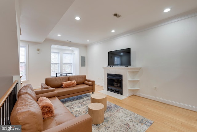 living room with a fireplace, wood finished floors, visible vents, and recessed lighting