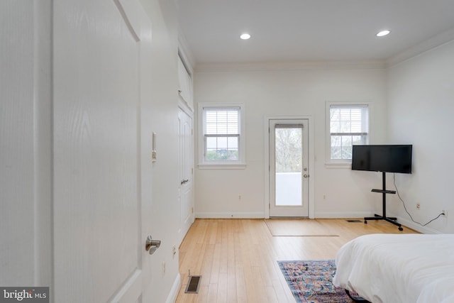 bedroom featuring ornamental molding, access to exterior, visible vents, and light wood-style floors