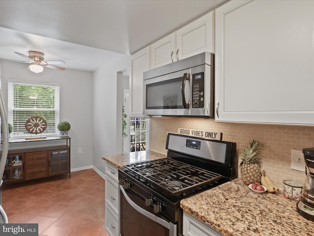6558 Gildar St, Alexandria, VA 22310 - kitchen featuring stainless steel appliances, tasteful backsplash, white cabinets, and light stone counters