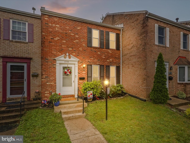 6558 Gildar St, Alexandria, VA 22310 - view of property featuring a front lawn, brick siding, and entry steps