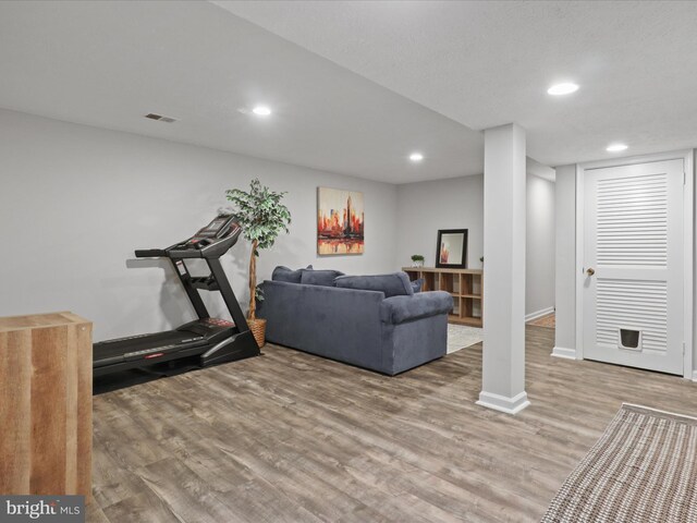 6558 Gildar St, Alexandria, VA 22310 - workout area with wood finished floors, baseboards, and recessed lighting