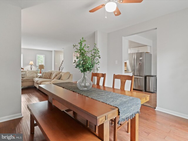 6558 Gildar St, Alexandria, VA 22310 - dining area featuring ceiling fan, baseboards, light wood-style floors, and stairs