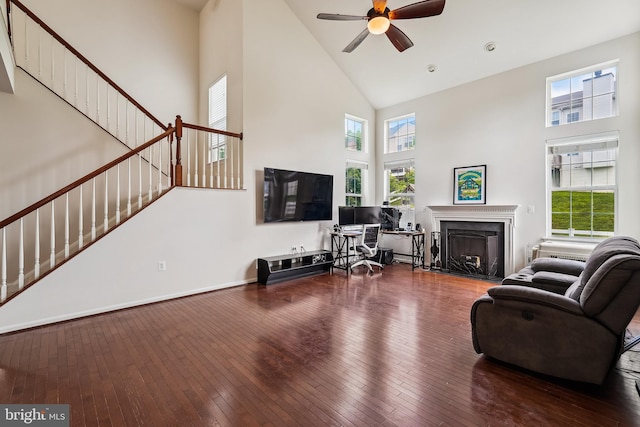 17365 Tedler Cir, Round Hill, VA 20141 - living area with high vaulted ceiling, stairs, hardwood / wood-style flooring, a fireplace, and plenty of natural light