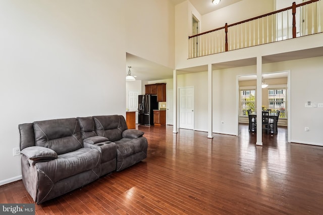17365 Tedler Cir, Round Hill, VA 20141 - living area featuring a high ceiling, dark wood-style flooring, and baseboards