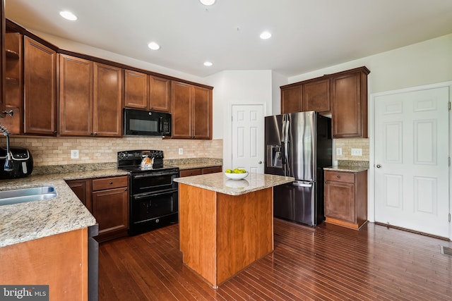 17365 Tedler Cir, Round Hill, VA 20141 - kitchen with black appliances, decorative backsplash, light stone counters, a center island, and recessed lighting