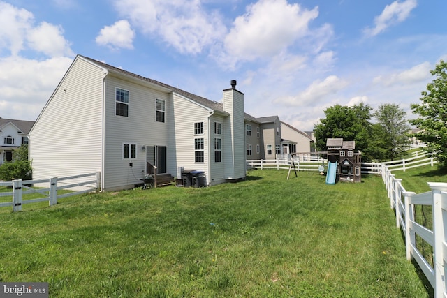 17365 Tedler Cir, Round Hill, VA 20141 - rear view of property with entry steps, a playground, and a chimney