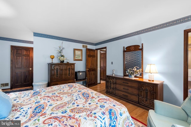 bedroom featuring light wood-style flooring