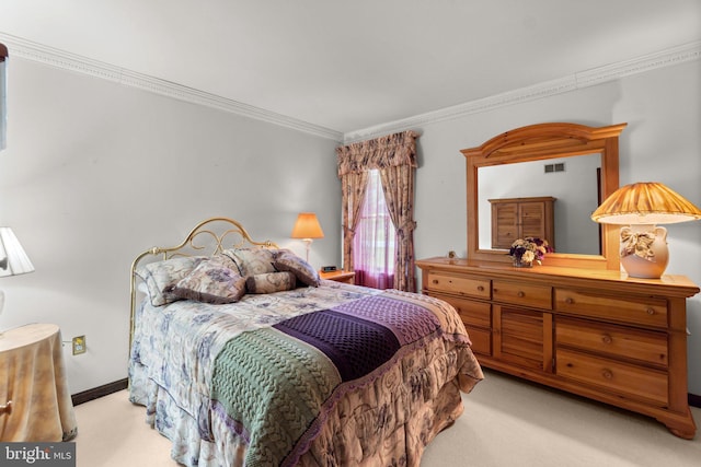 bedroom with carpet flooring, ornamental molding, and baseboards