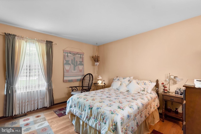 bedroom featuring wood finished floors and access to outside