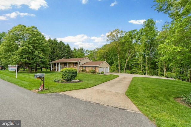 view of front of home featuring a front lawn, concrete driveway, brick siding, and an attached garage