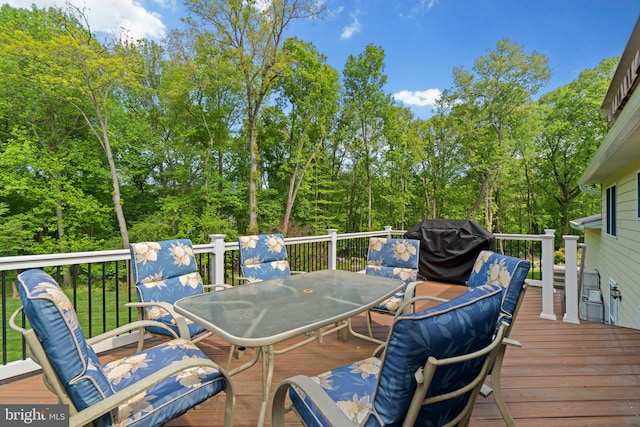 wooden terrace featuring outdoor dining space