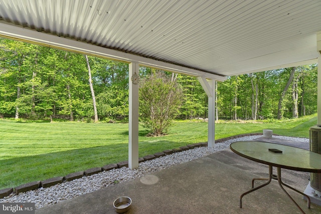 view of patio / terrace with a wooded view