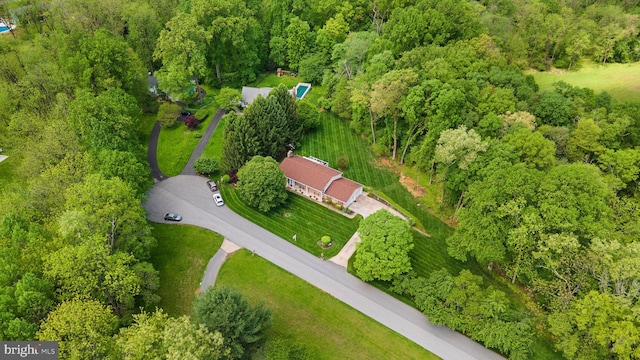 aerial overview of property's location with a forest