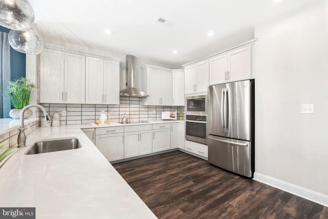 204 Baldy Ln Cayot, Unit Cayot, Middletown, DE 19709 - kitchen with appliances with stainless steel finishes, wall chimney exhaust hood, a sink, light countertops, and dark wood-style flooring