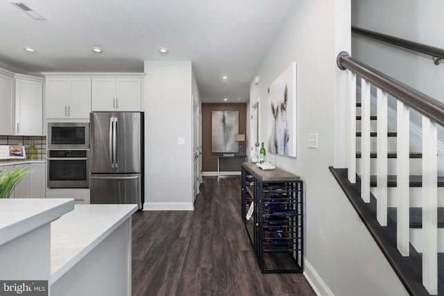 204 Baldy Ln Cayot, Unit Cayot, Middletown, DE 19709 - kitchen with stainless steel appliances, dark wood finished floors, light countertops, white cabinets, and baseboards