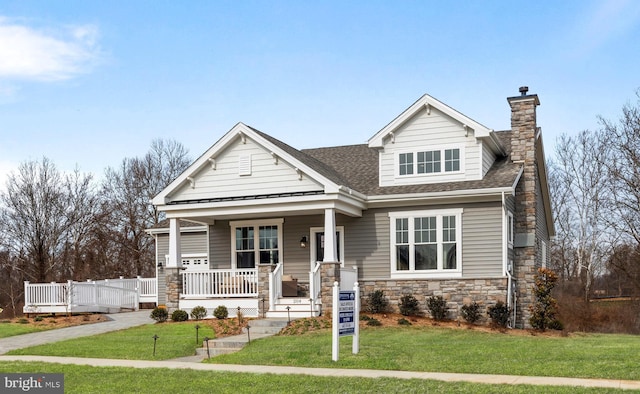 204 Baldy Ln Cayot, Unit Cayot, Middletown, DE 19709 - craftsman inspired home with stone siding, roof with shingles, a porch, a front lawn, and a chimney