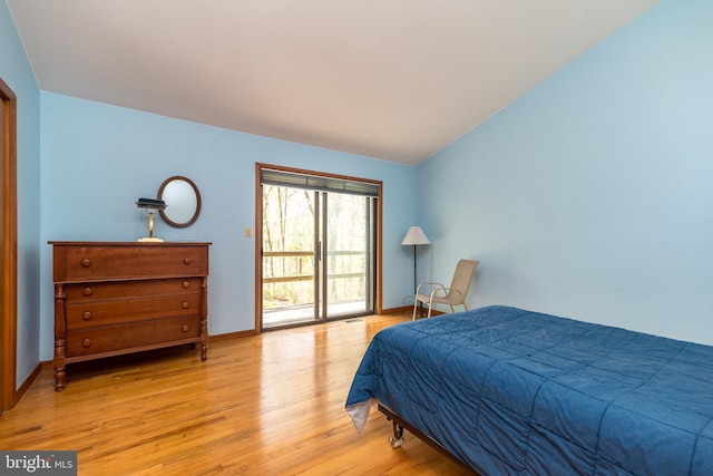 bedroom with vaulted ceiling, light wood-style flooring, access to exterior, and baseboards
