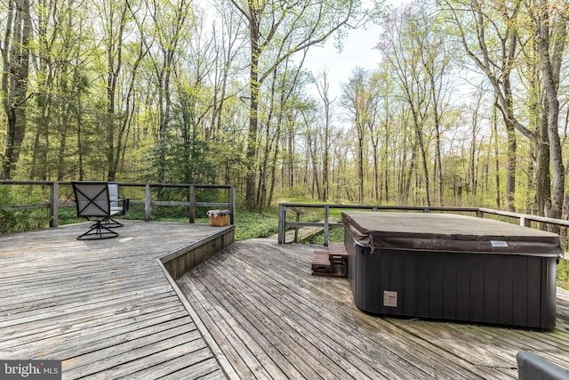 wooden deck with a hot tub