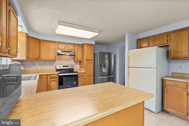 12916 New Hampshire Ave, Silver Spring, MD 20904 - kitchen featuring stainless steel appliances, under cabinet range hood, light countertops, backsplash, and a textured ceiling