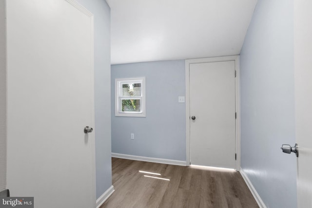interior space with baseboards and wood finished floors