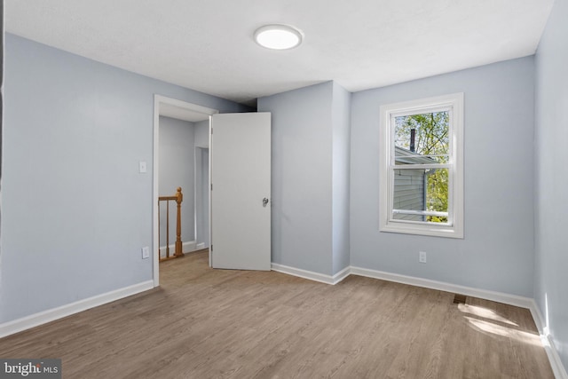 unfurnished bedroom featuring baseboards and wood finished floors