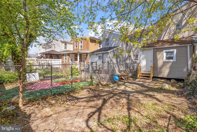 back of property featuring fence and entry steps
