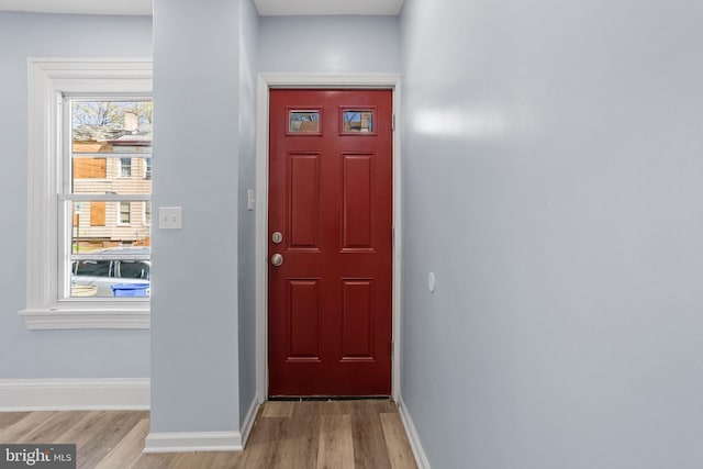 interior space featuring baseboards and wood finished floors