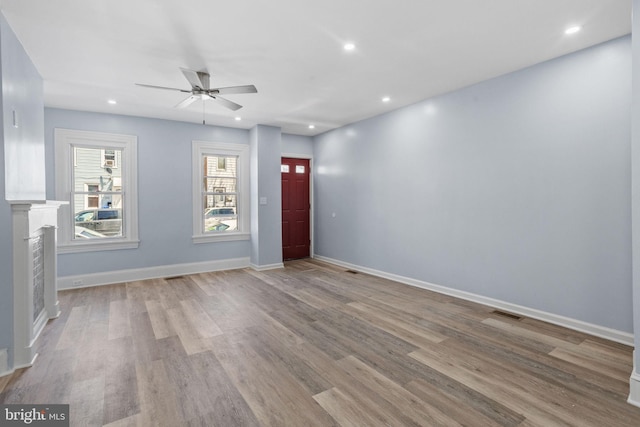 unfurnished living room with baseboards, wood finished floors, recessed lighting, and ceiling fan