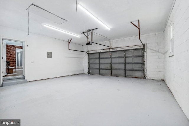garage featuring a garage door opener and electric panel