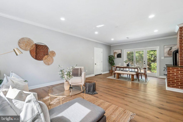 living area with crown molding, baseboards, recessed lighting, and wood finished floors