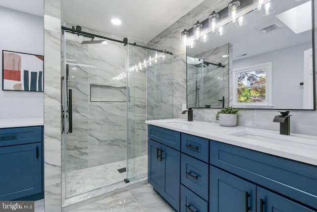 bathroom with visible vents, a marble finish shower, a sink, and marble finish floor
