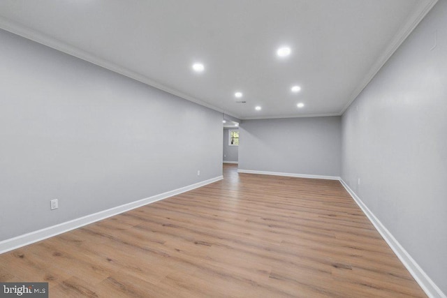 basement with crown molding, recessed lighting, baseboards, and light wood-style floors