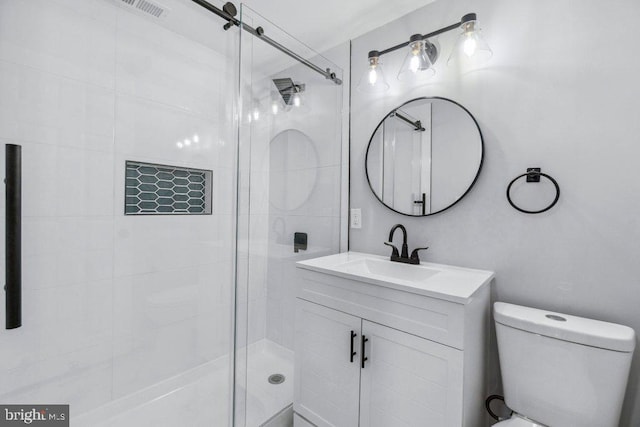 full bath featuring vanity, toilet, and a shower stall