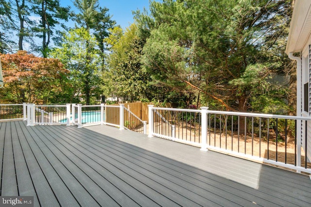 deck featuring a fenced in pool