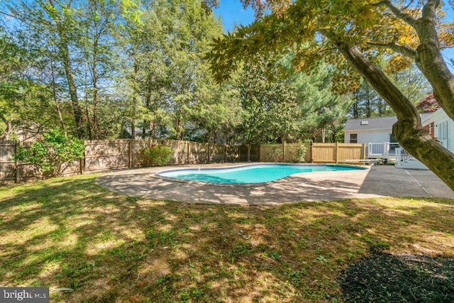 view of pool featuring a lawn, a patio, a fenced in pool, and a fenced backyard