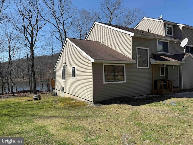 3301 Windermere Dr, Bushkill, PA 18324 - back of house with a lawn and roof with shingles