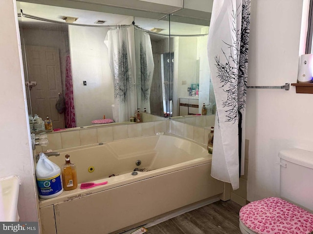 3301 Windermere Dr, Bushkill, PA 18324 - bathroom featuring visible vents, wood finished floors, a whirlpool tub, and toilet