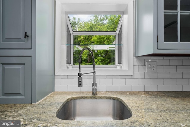 413 Bucktoe Rd, Avondale, PA 19311 - kitchen with a sink, backsplash, light stone countertops, and glass insert cabinets