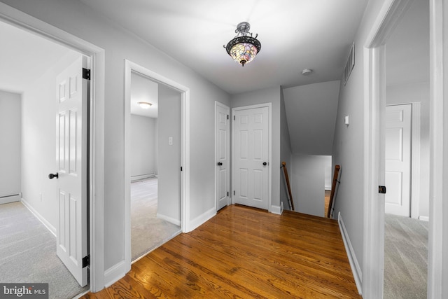 413 Bucktoe Rd, Avondale, PA 19311 - corridor featuring an upstairs landing, baseboards, wood finished floors, and baseboard heating