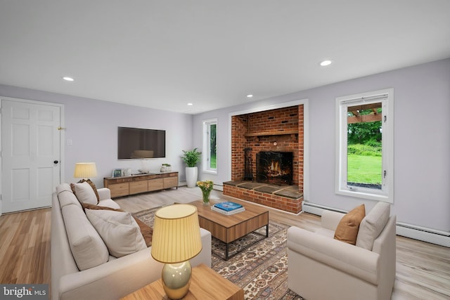 413 Bucktoe Rd, Avondale, PA 19311 - living room featuring plenty of natural light, light wood-style flooring, a fireplace, recessed lighting, and a baseboard radiator