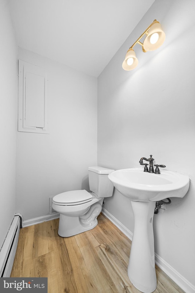 413 Bucktoe Rd, Avondale, PA 19311 - bathroom with baseboard heating, wood finished floors, toilet, and a sink