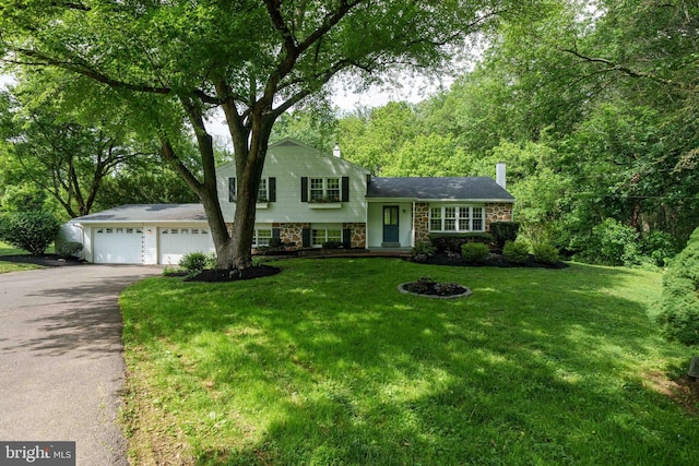 413 Bucktoe Rd, Avondale, PA 19311 - split level home featuring driveway, a chimney, a front yard, and an attached garage