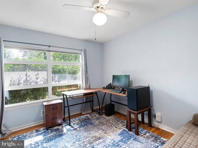 home office featuring baseboards, ceiling fan, and wood finished floors