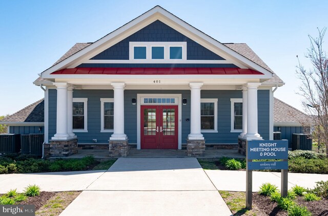 craftsman-style house featuring french doors, a porch, and a shingled roof