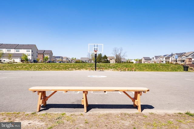 view of basketball court with a residential view