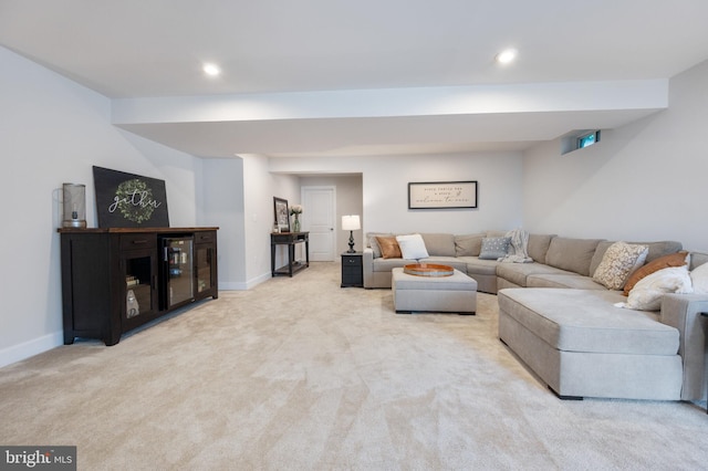 carpeted living area featuring recessed lighting and baseboards