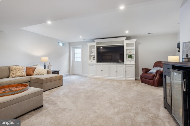 living area featuring wine cooler, light colored carpet, recessed lighting, and baseboards