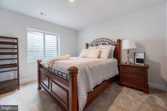 bedroom featuring baseboards and light colored carpet
