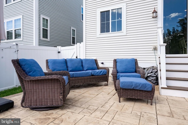 view of patio / terrace featuring outdoor lounge area, a fenced backyard, and a gate