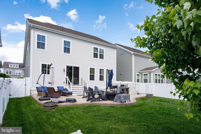 back of property with a gate, entry steps, and a patio area